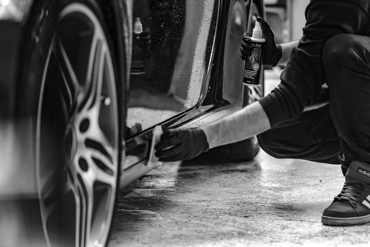 A person working on the tire of a car.