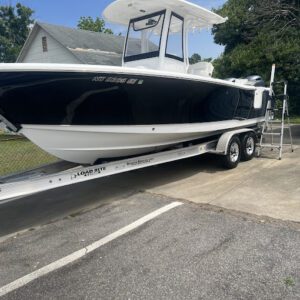 A boat is being loaded onto the trailer.