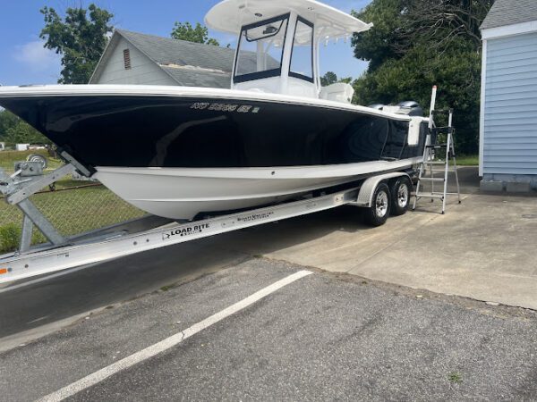 A boat is being loaded onto the trailer.