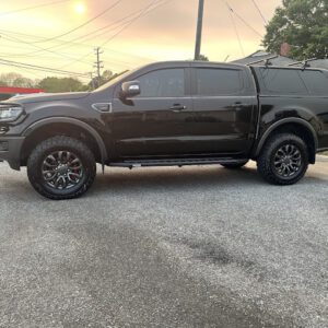 A black truck parked in the parking lot