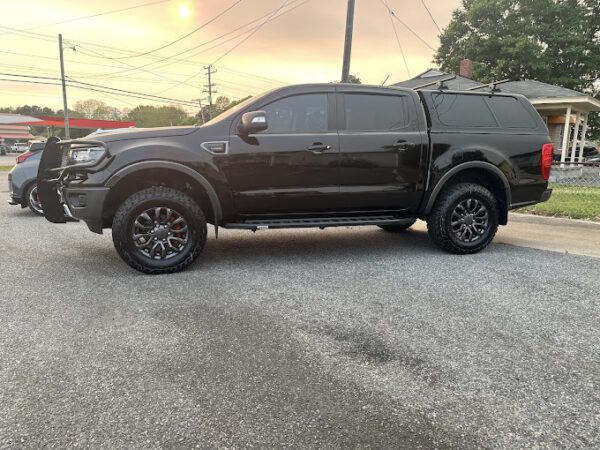 A black truck parked in the parking lot