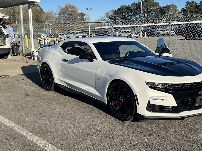 A white sports car parked in the parking lot.
