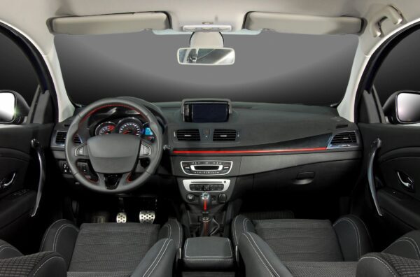 A car dashboard with the steering wheel and dash.