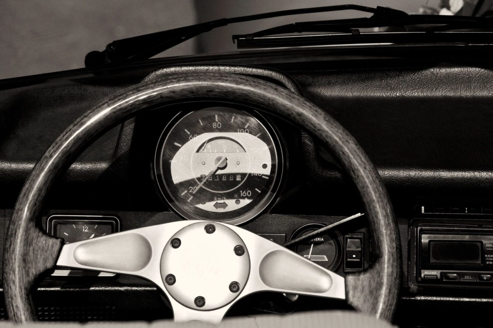 A close up of the dashboard and speedometer in a car
